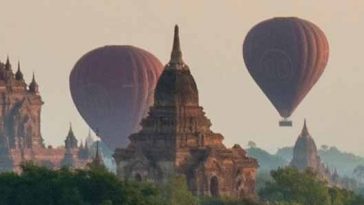 Photo of hot air balloons rising into the sky over Bagan, Burma.