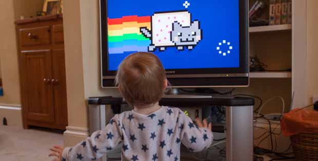 Photograph of a child watching the famous Nyan Cat video.